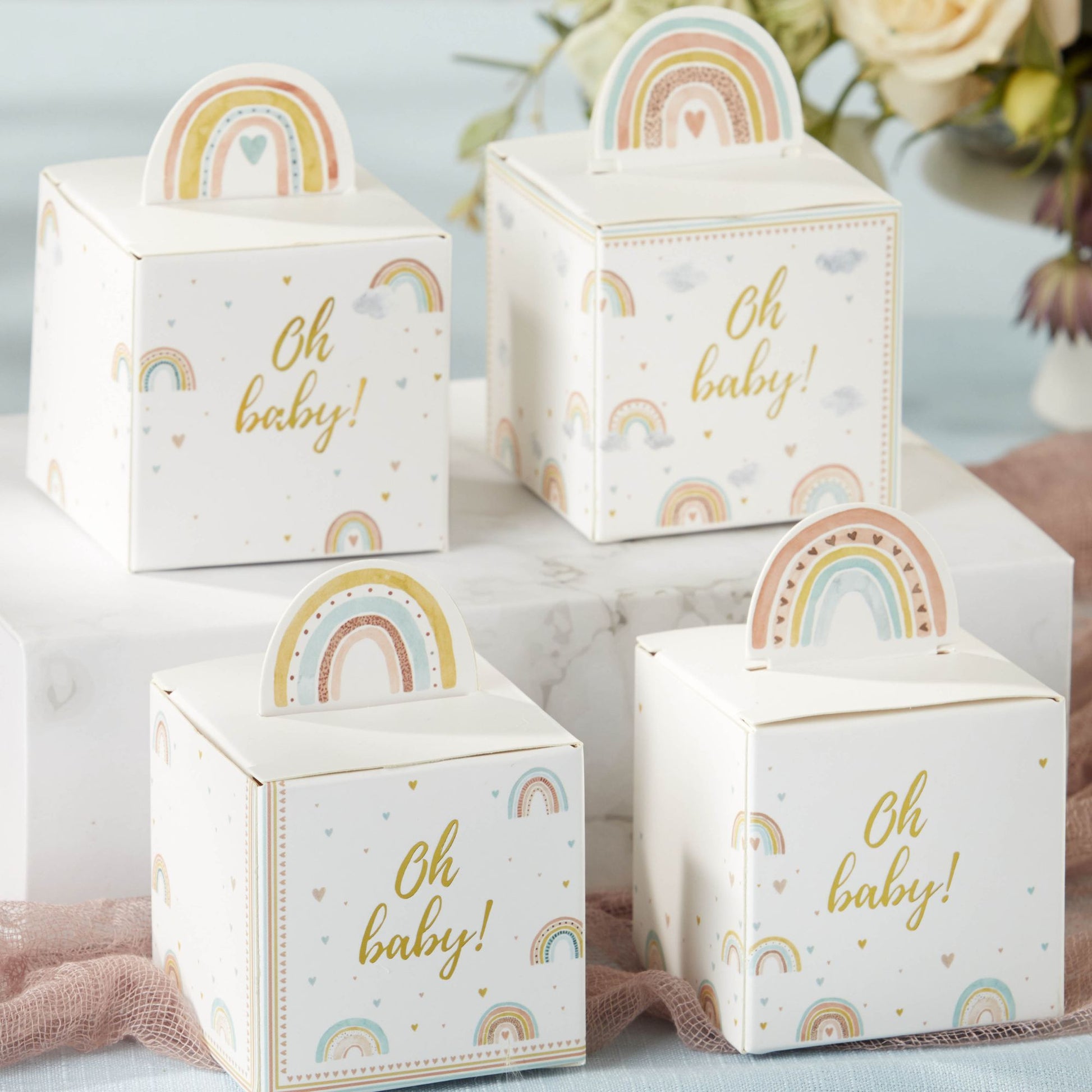 four boho rainbow baby shower favor boxes showing four sides